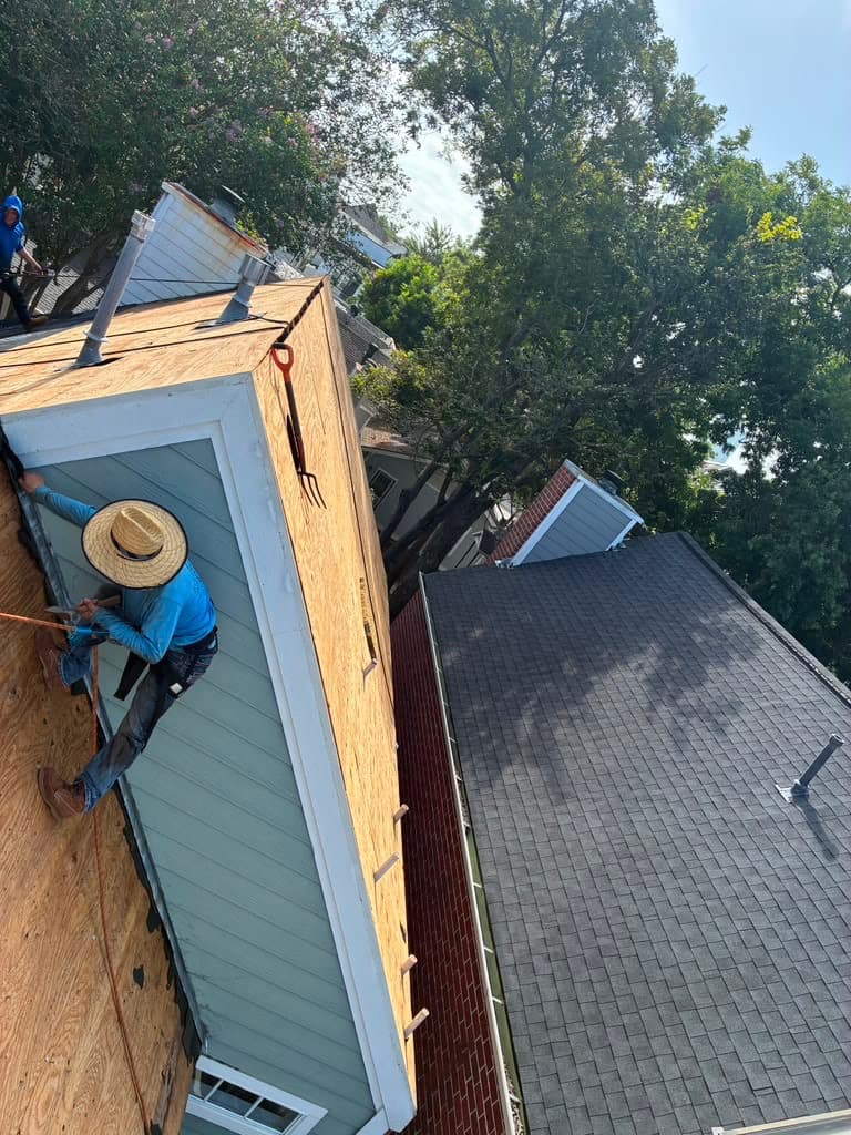 Bluebonnet roofer climbing a steep re-decked roof during an inspection
