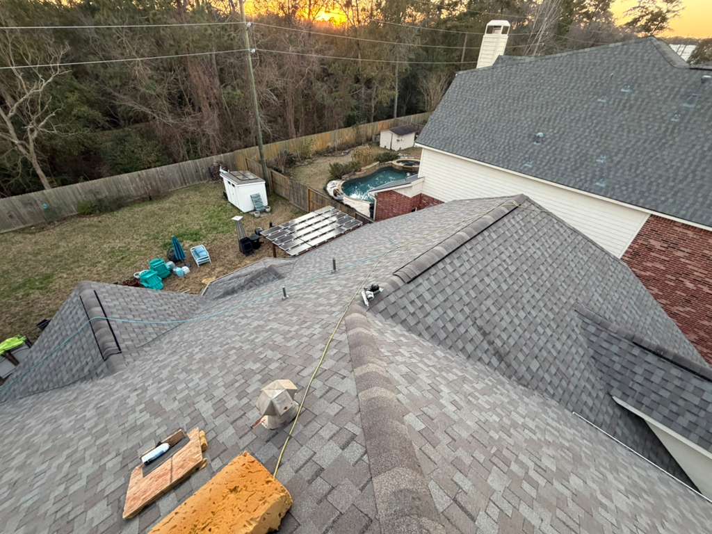 Completed roof valleys and hips glowing at sunset