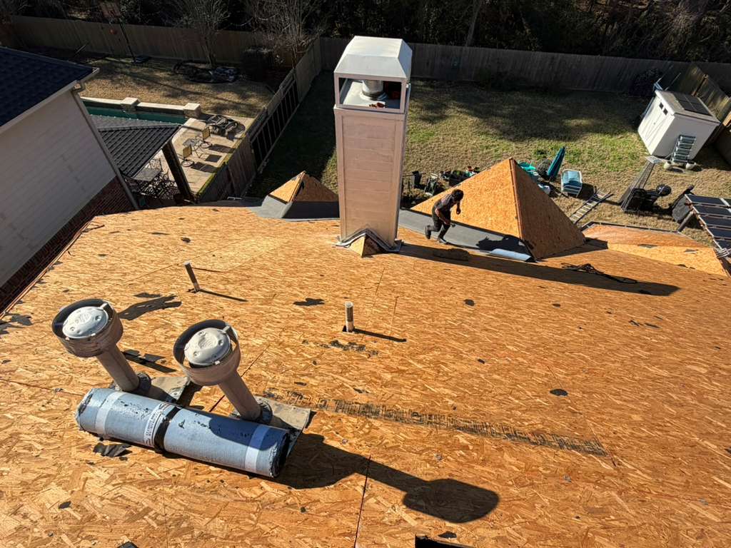 Fully re-decked roof with chimney chase, vent stacks, and rolled underlayment