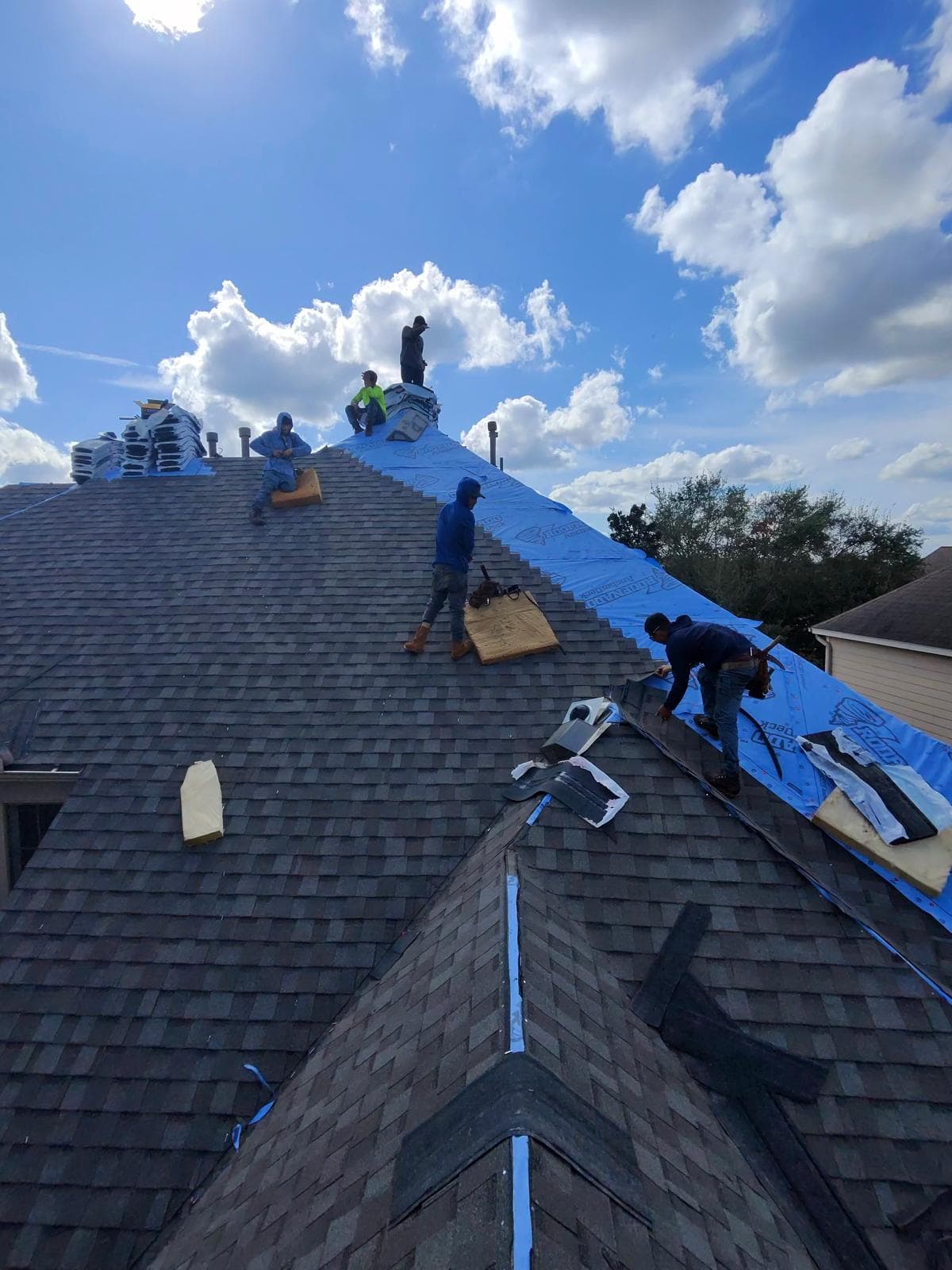 A Bluebonnet crew installing a new shingle roof on a Houston home