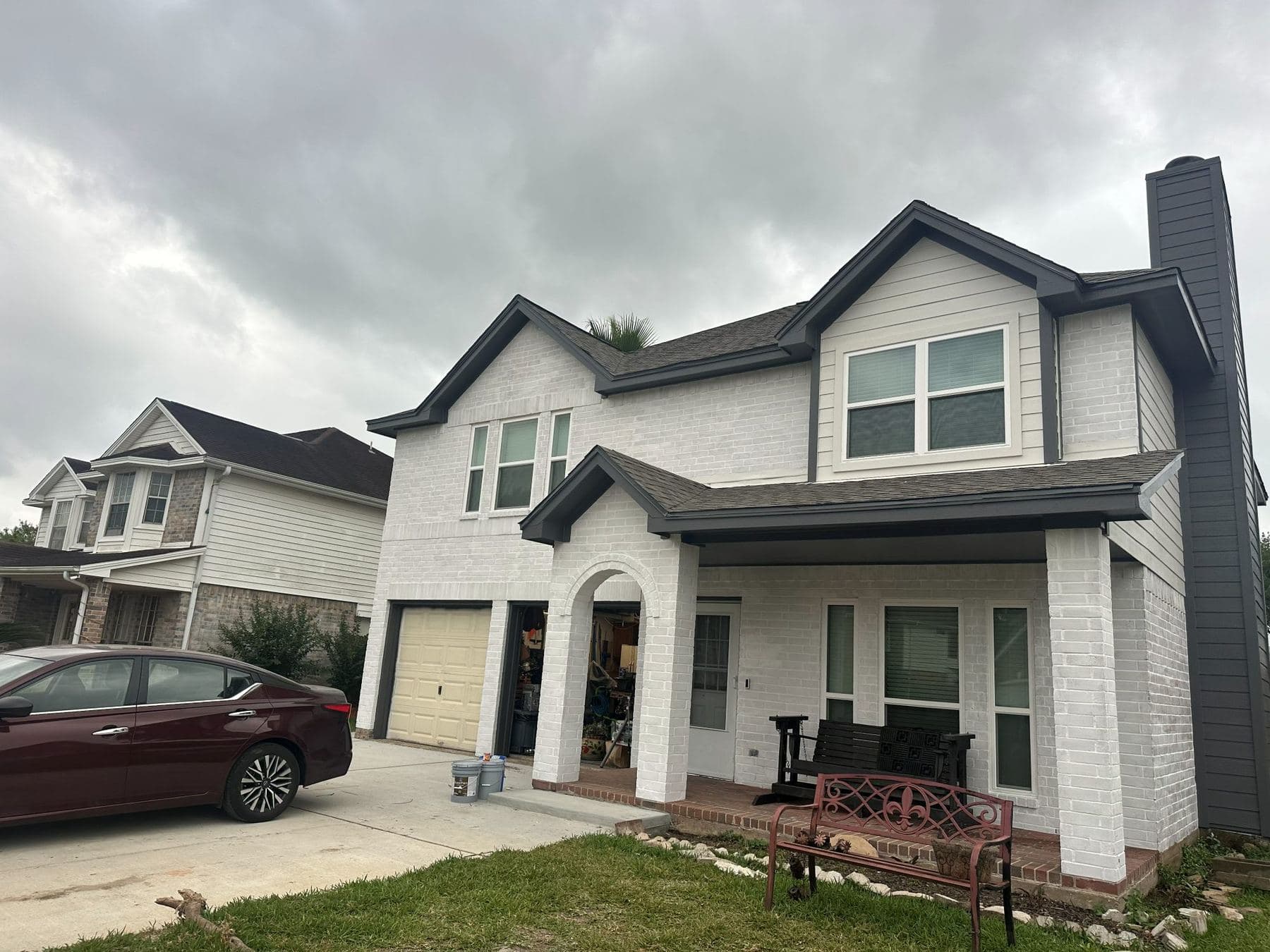 Two-story home in fresh white James Hardie lap siding with charcoal trim