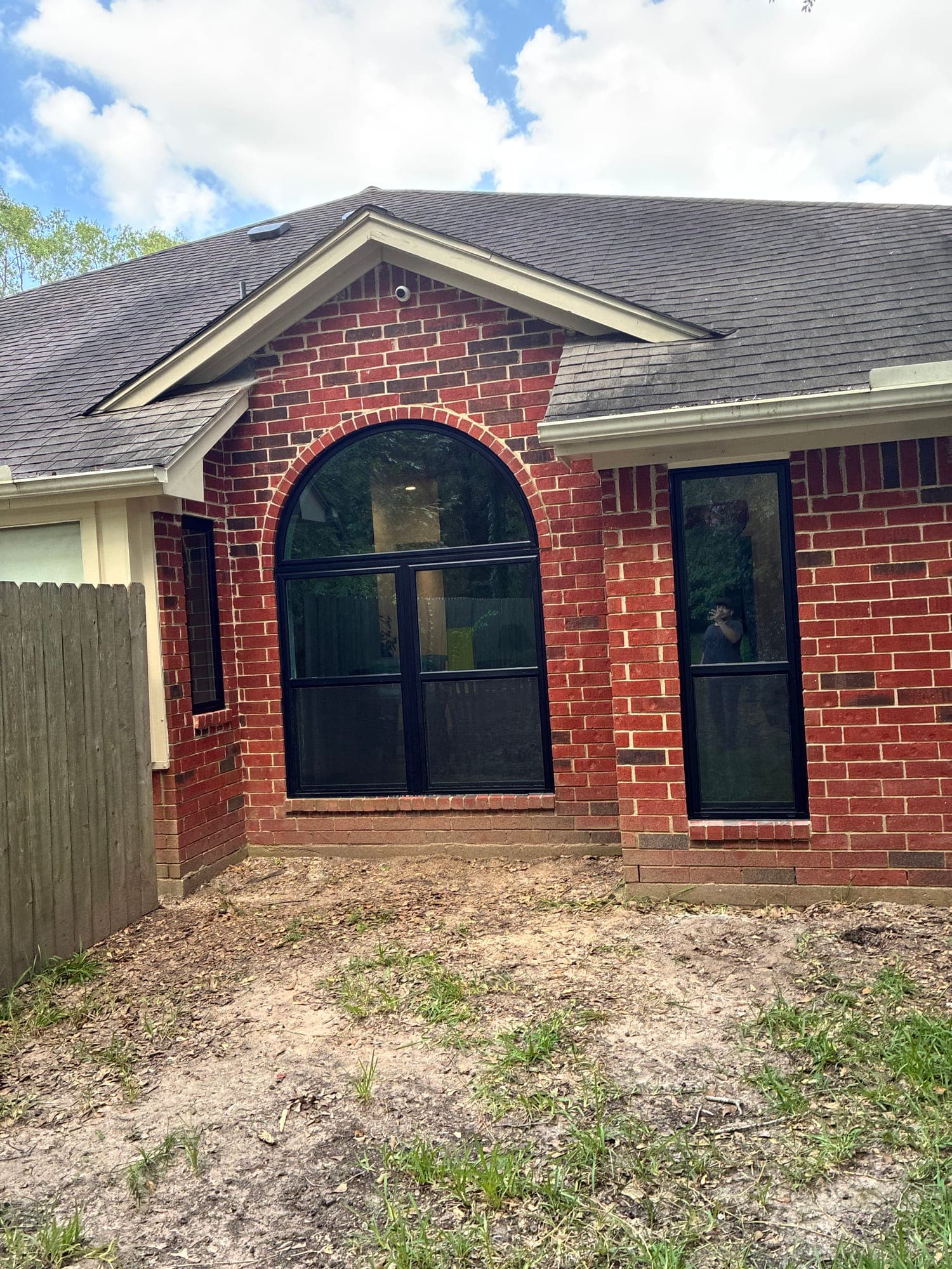 Black arch-top specialty window in a gable
